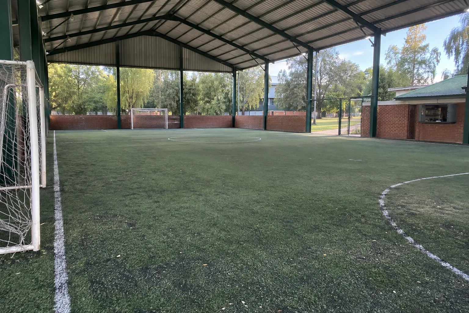 Cancha de fútbol 7 techada de Don Bosco, con estructura verde y césped sintético